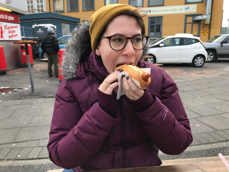 The co-author, Fran Hoepfner, samples an Icelandic hot dog for the first time. (Photo: Cameron Scheetz)